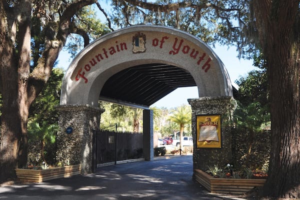 An archway with the words "Fountain of Youth" and a sign that says "ENTER".