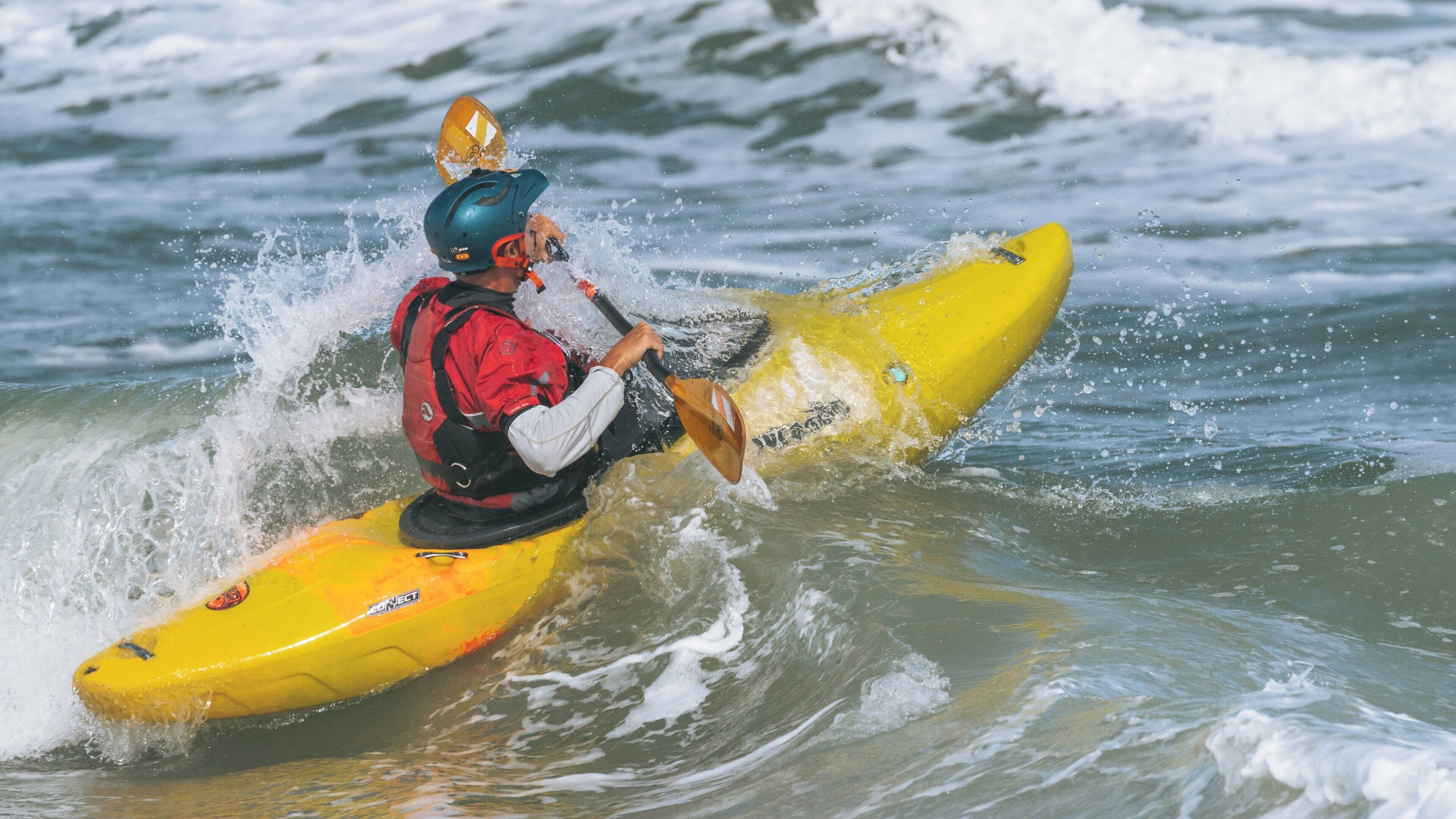 Exciting kayaking experience at Anastasia State Park in St. Augustine, Florida with waves crashing on a sunny day