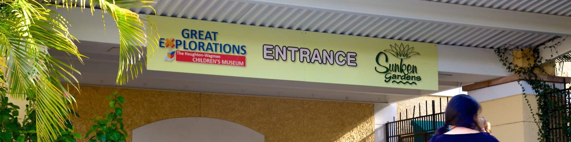 The entrance to the Great Explorations Children's Museum with a sign for Sunken Gardens.