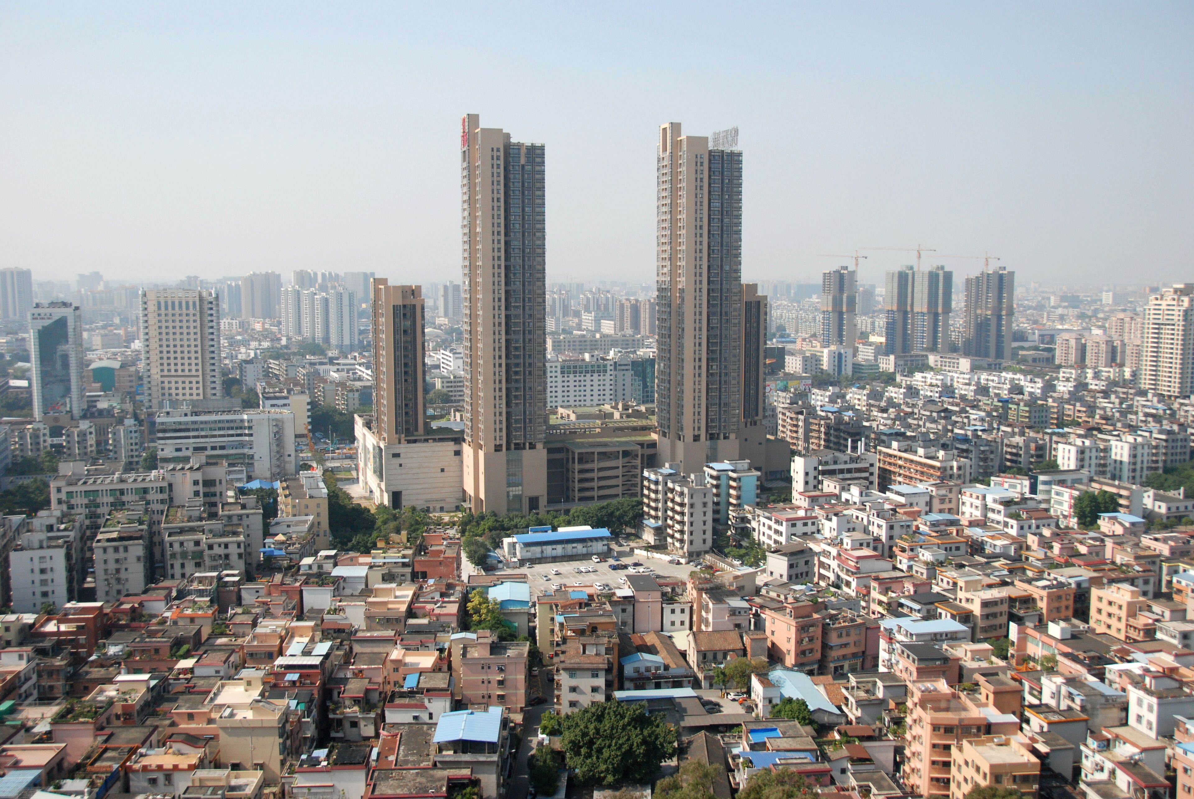 A densely packed urban area with numerous high-rise buildings and a mix of residential and commercial structures.