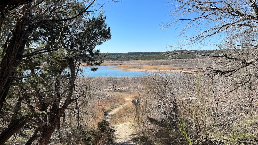 A hiking trail leading down toward a lake in a Texas Hill Country Park, Stillhouse Hollow Lake, Dana Peak Hike and Bike park, Harker Hights, Texas