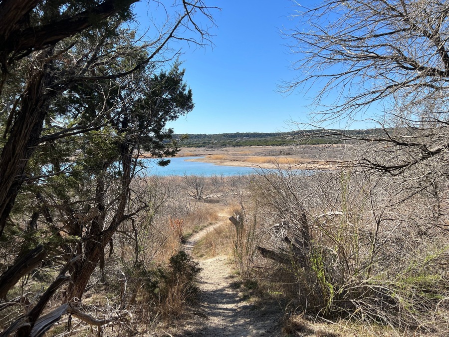 A hiking trail leading down toward a lake in a Texas Hill Country Park, Stillhouse Hollow Lake, Dana Peak Hike and Bike park, Harker Hights, Texas