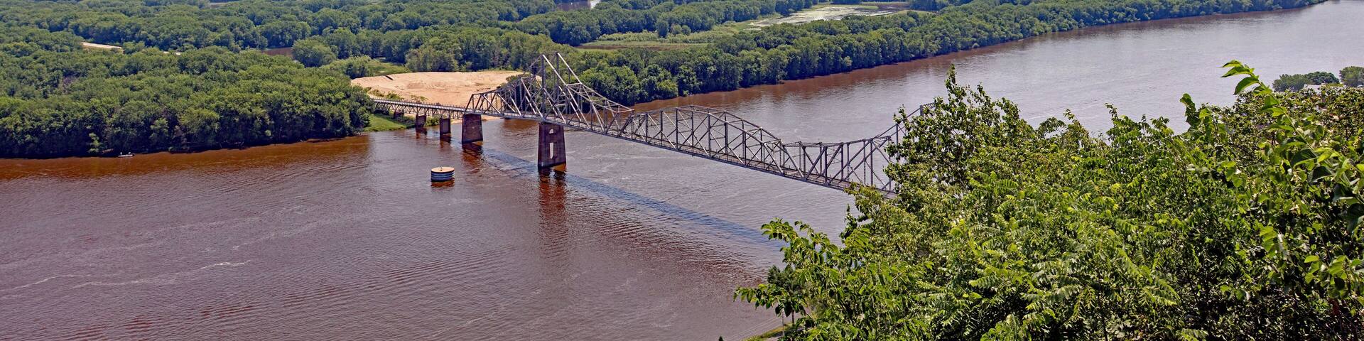 The Black Hawk Bridge spans the Mississippi River, joining Lansing IA, to WI. A riveted iron truss bridge built in 1931 from a scenic overlook mount Hosmer.