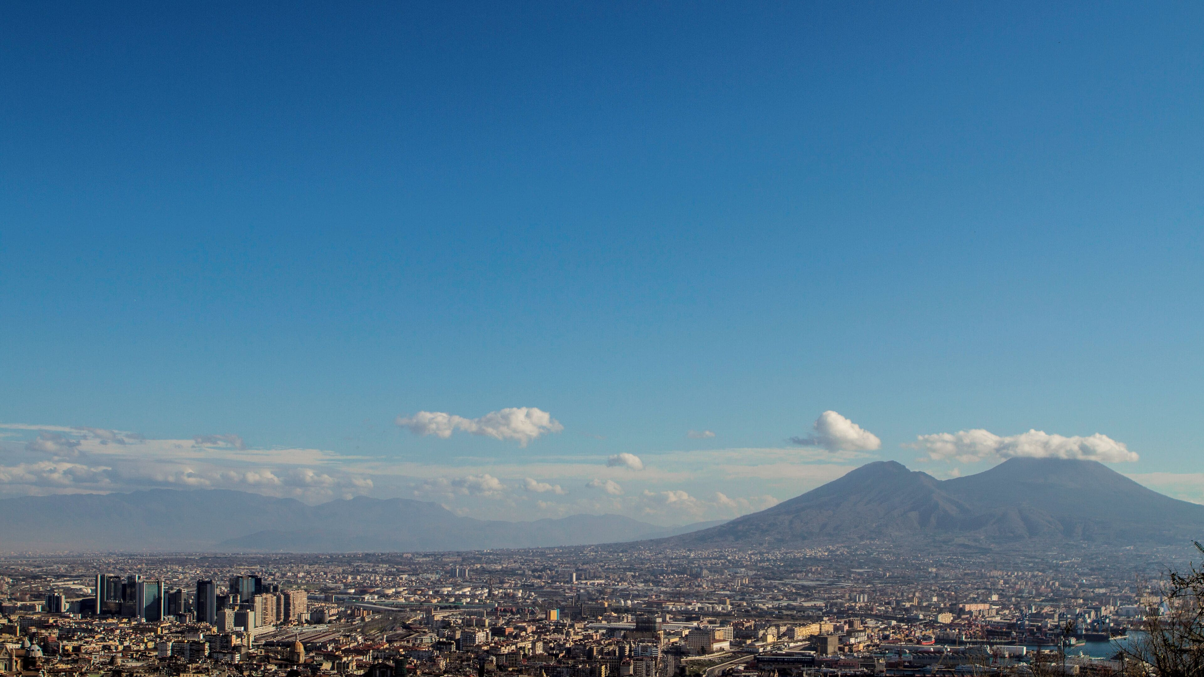 Naples is one of the oldest continuously-inhabited cities in the world. Bronze Age Greek settlements were established on the site in the 2nd millennium BC, with a larger mainland colony – initially known as Parthenope – developing around the 9th–8th centuries BC, at the end of the Greek Dark Ages. The city was refounded as Neápolis in the 6th century BC and became a linchpin of Magna Graecia, playing a key role in the merging of Greek culture into Roman society and eventually becoming a cultural centre of the Roman Republic. Naples remained influential after the fall of the Western Roman Empire, serving as the capital city of the Kingdom of Naples between 1282 and 1816. Thereafter, in union with Sicily, it became the capital of the Two Sicilies until the unification of Italy in 1861. During the Neapolitan War of 1815, Naples strongly promoted Italian unification.Naples was the most-bombed Italian city during World War II. Much of the city's 20th-century periphery was constructed under Benito Mussolini's fascist government, and during reconstruction efforts after World War II. In recent decades, Naples has constructed a large business district, the Centro Direzionale, and has developed an advanced transport infrastructure, including an Alta Velocità high-speed rail link to Rome and Salerno, and an expanded subway network, which is planned to eventually cover half of the region. The city has experienced significant economic growth in recent decades, and unemployment levels in the city and surrounding Campania have decreased since 1999. However, Naples is still characterized by political and economic corruption and a thriving black market, and unemployment levels remain high. http://en.wikipedia.org/wiki/Naples