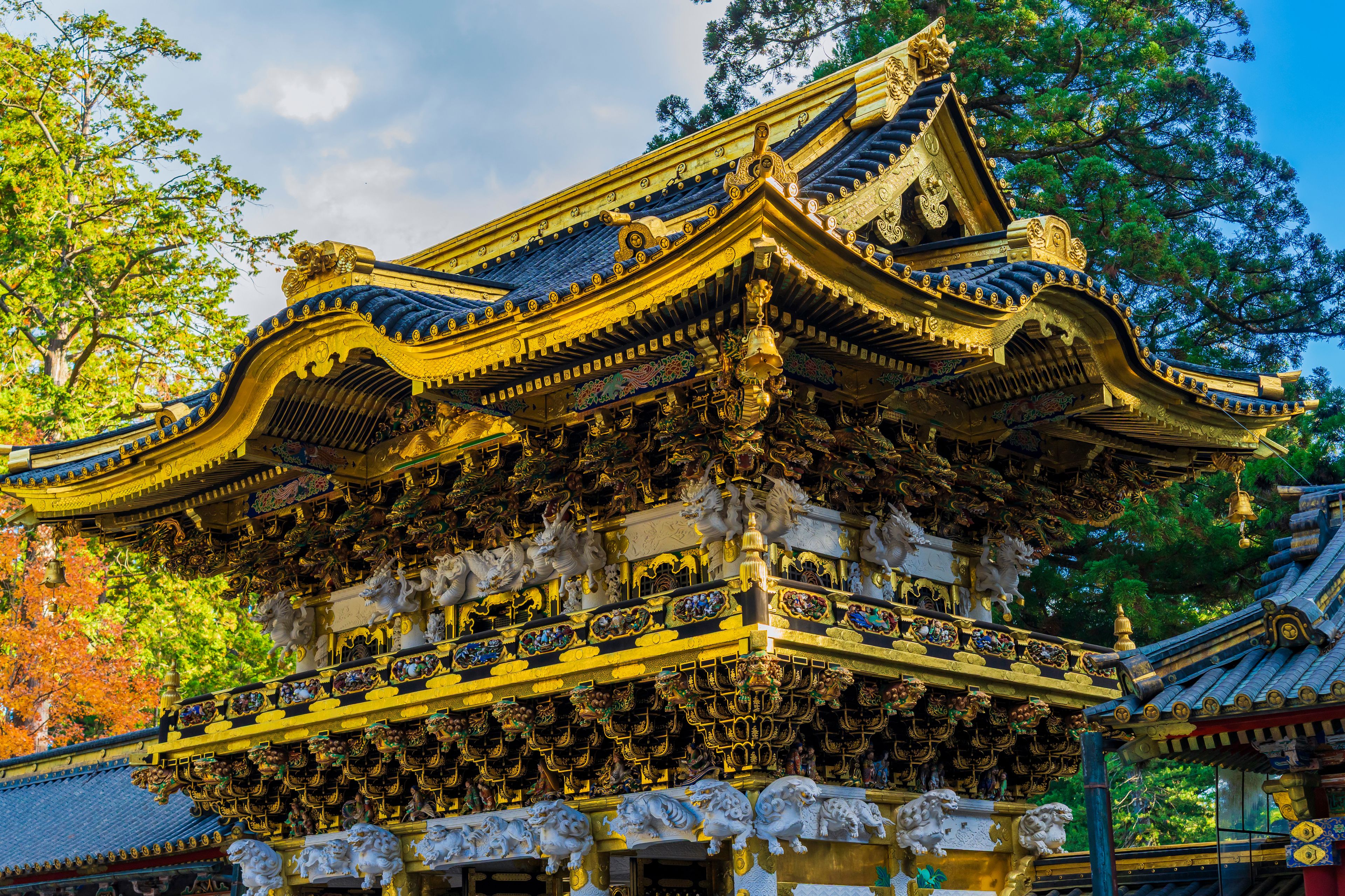 A traditional temple with ornate golden roofs and intricate carvings.