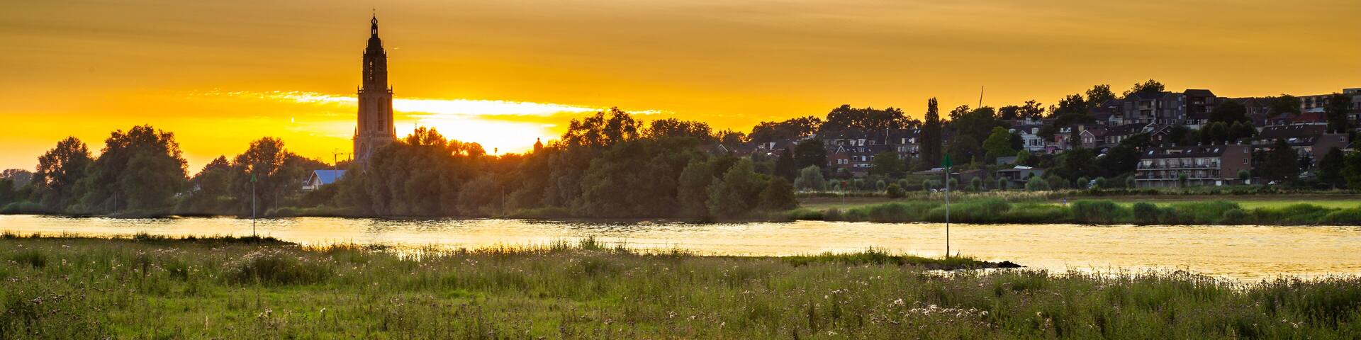 Skyline of the city of Rhenen during sunset with Cunera church and river Nederrrijn in the provence of Utrecht in the Netherlands