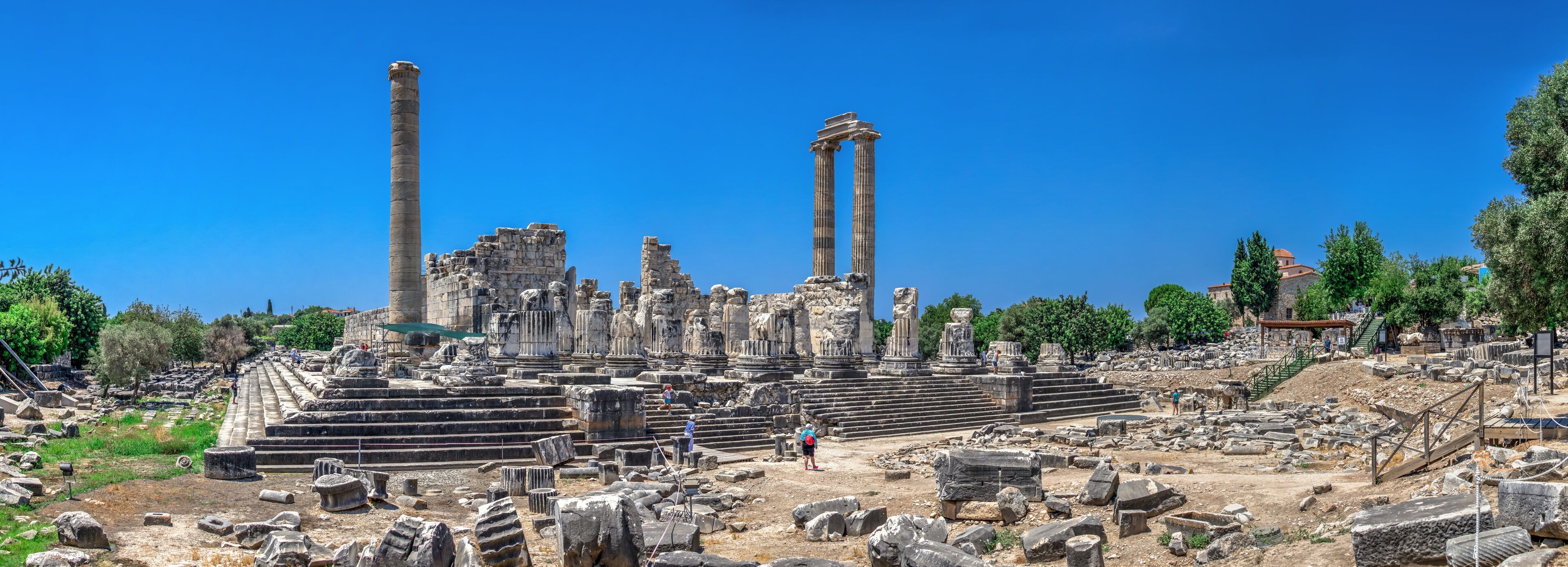 Ancient ruins with columns and stone steps.