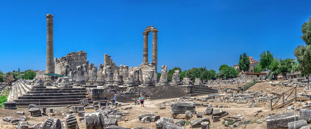 Ancient ruins with columns and stone steps.
