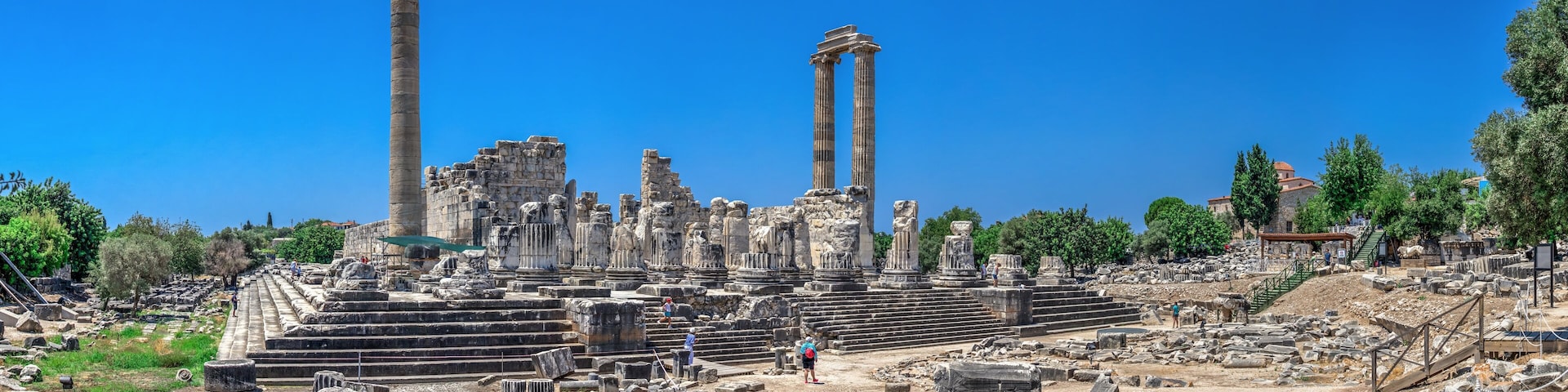 Ancient ruins with columns and stone steps.