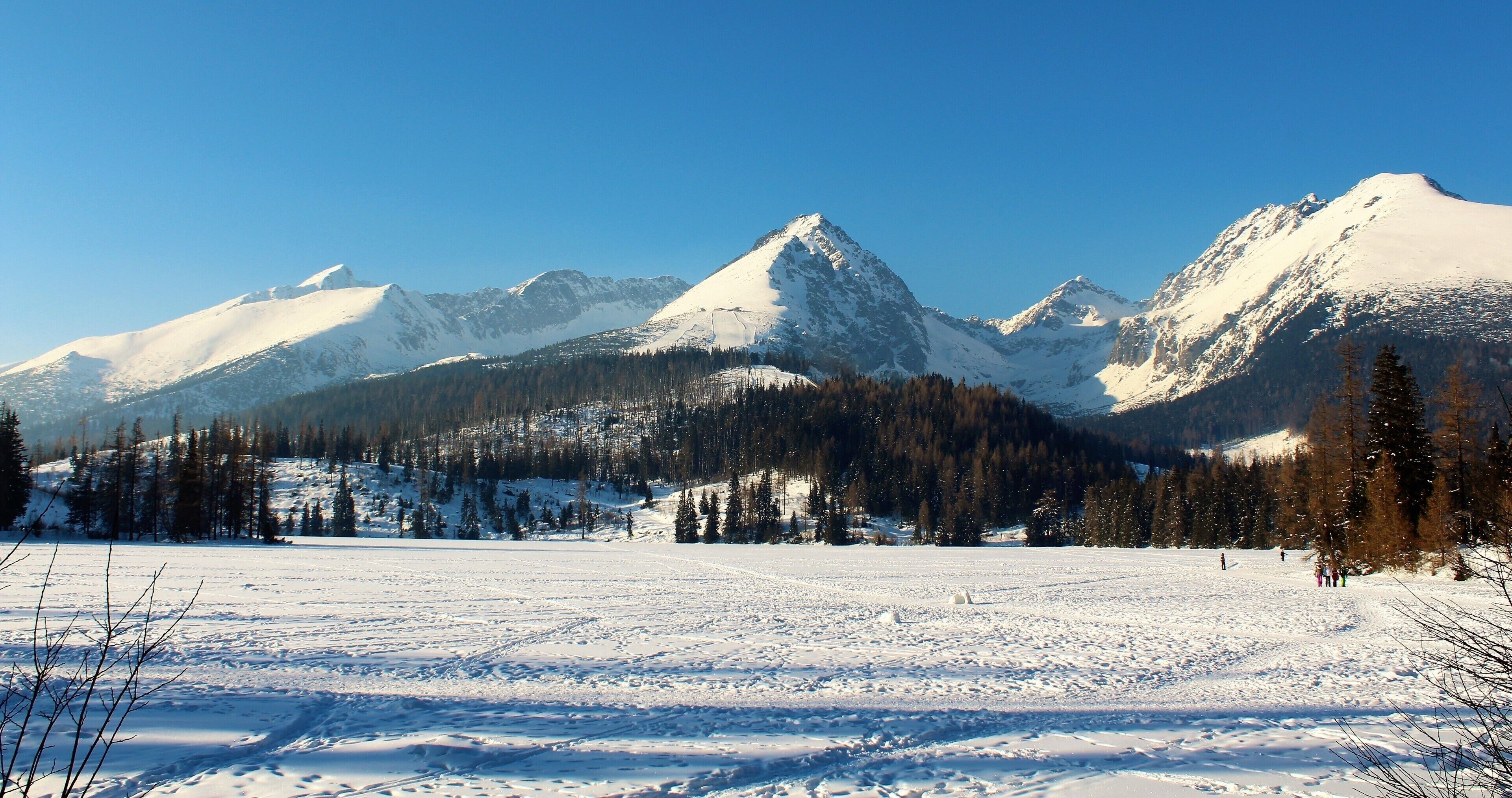 A snow-covered mountain range with clear skies.