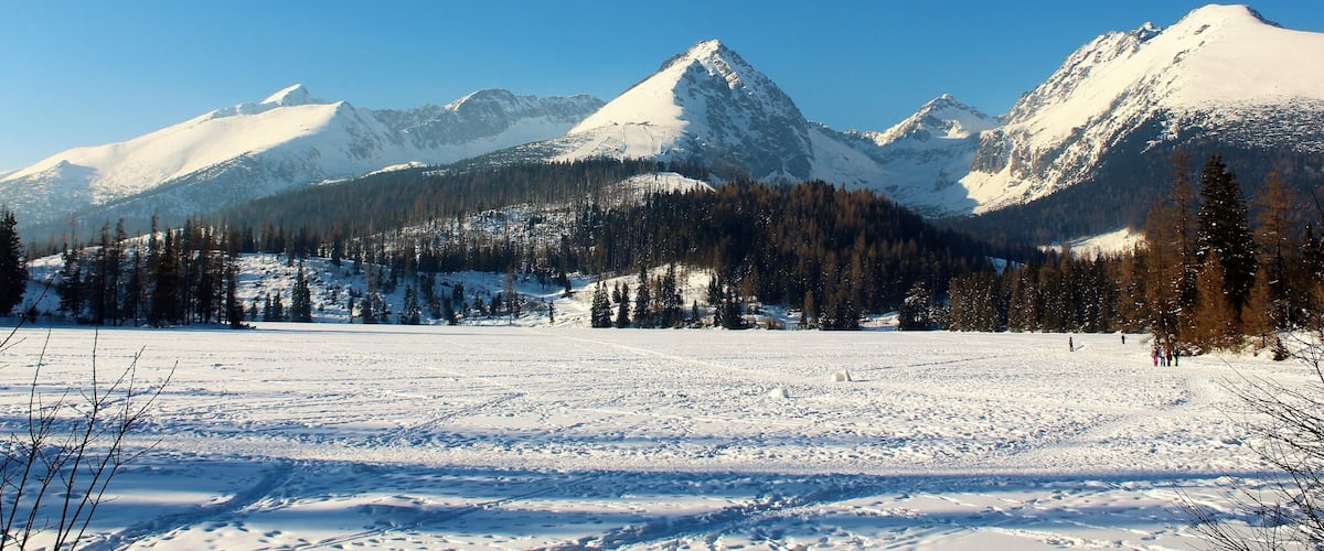 A snow-covered mountain range with clear skies.