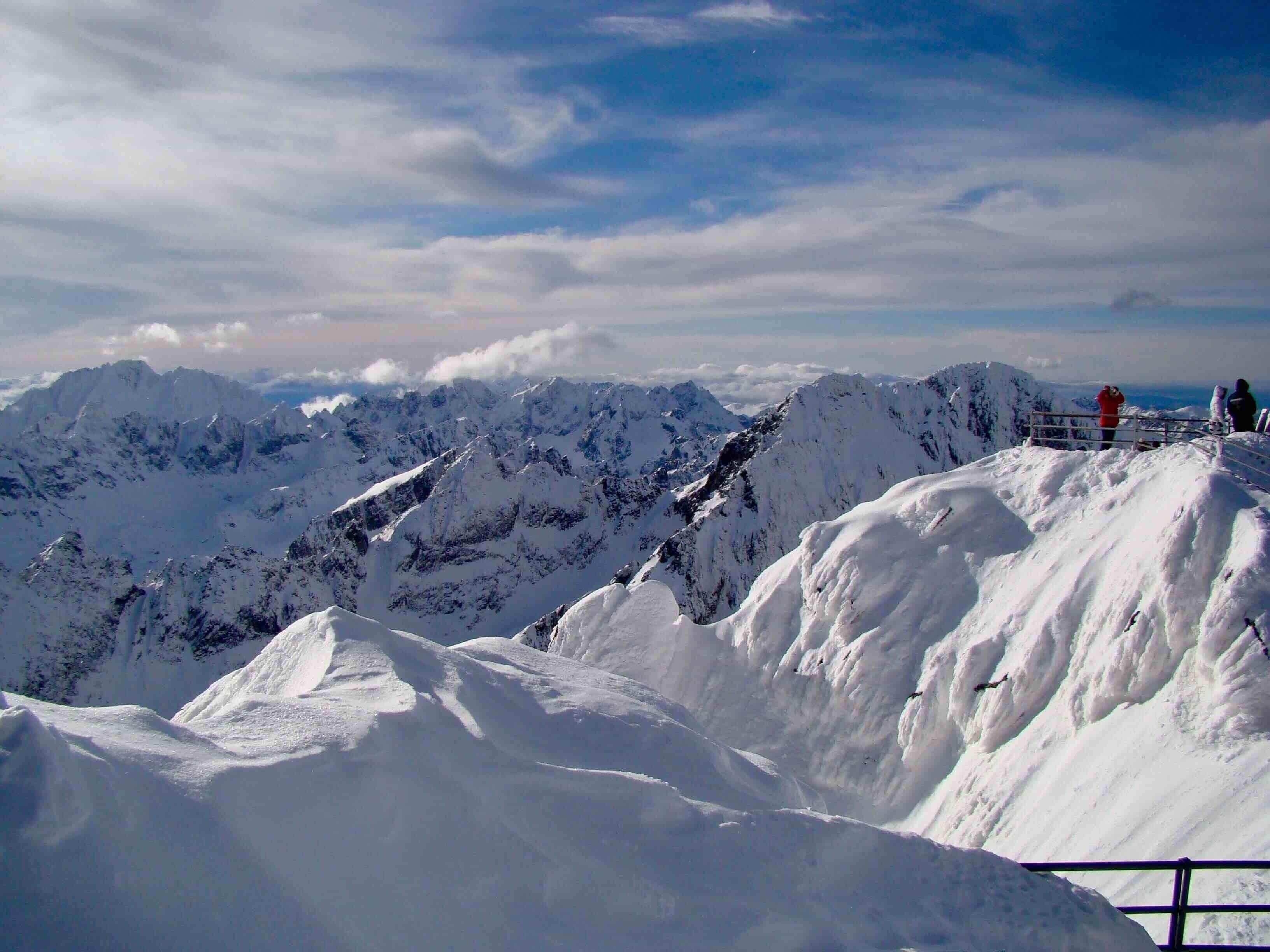 A snow-covered mountain range with a clear sky.