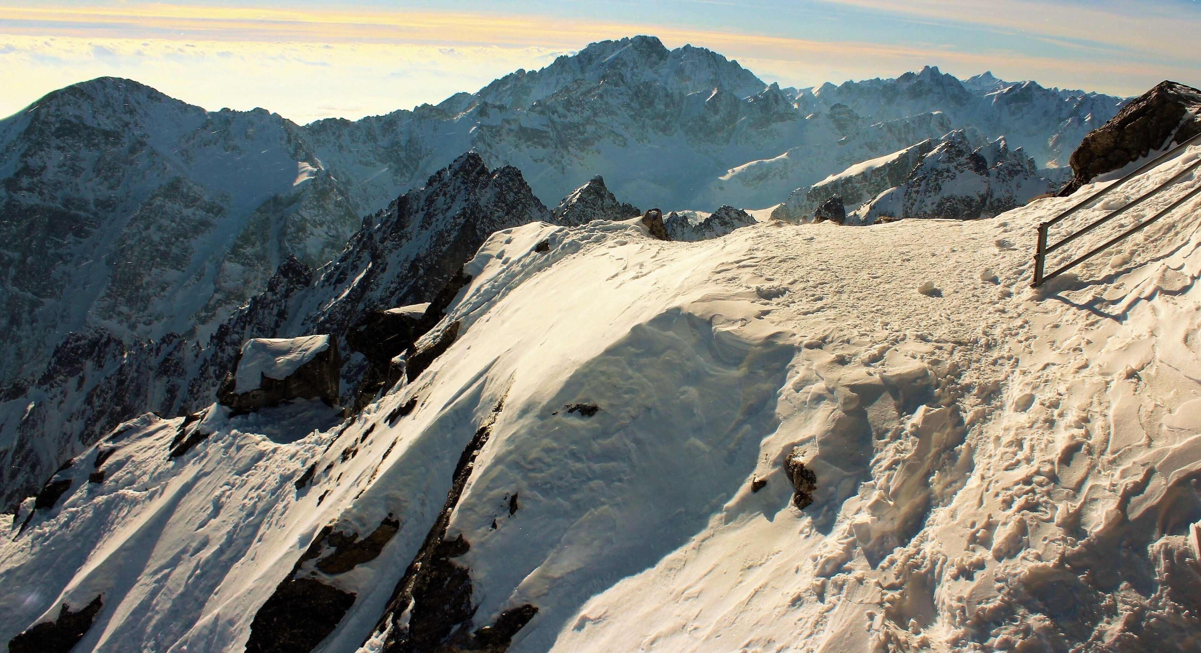 In the High Tatras, at Lomnický Peak. I was 2634 m/8641 ft above sea level. The mountains were breathtaking to see! But the wind was so strong I couldn't walk wherever I'd like! In fact I even lost my cap to the wind ;). It was incredible experience being up there. Exhilarating to say the least! I took the cable car up to Lomnický Peak (Slovak: Lomnický štít). And the views from there were also amazing. Lomnický štít is the 2nd highest peak in the High Tatras Mountains and one of the most visited in Slovakia. For very good reason! I took a lot of photos there even though I was holding my camera very, very tight! 