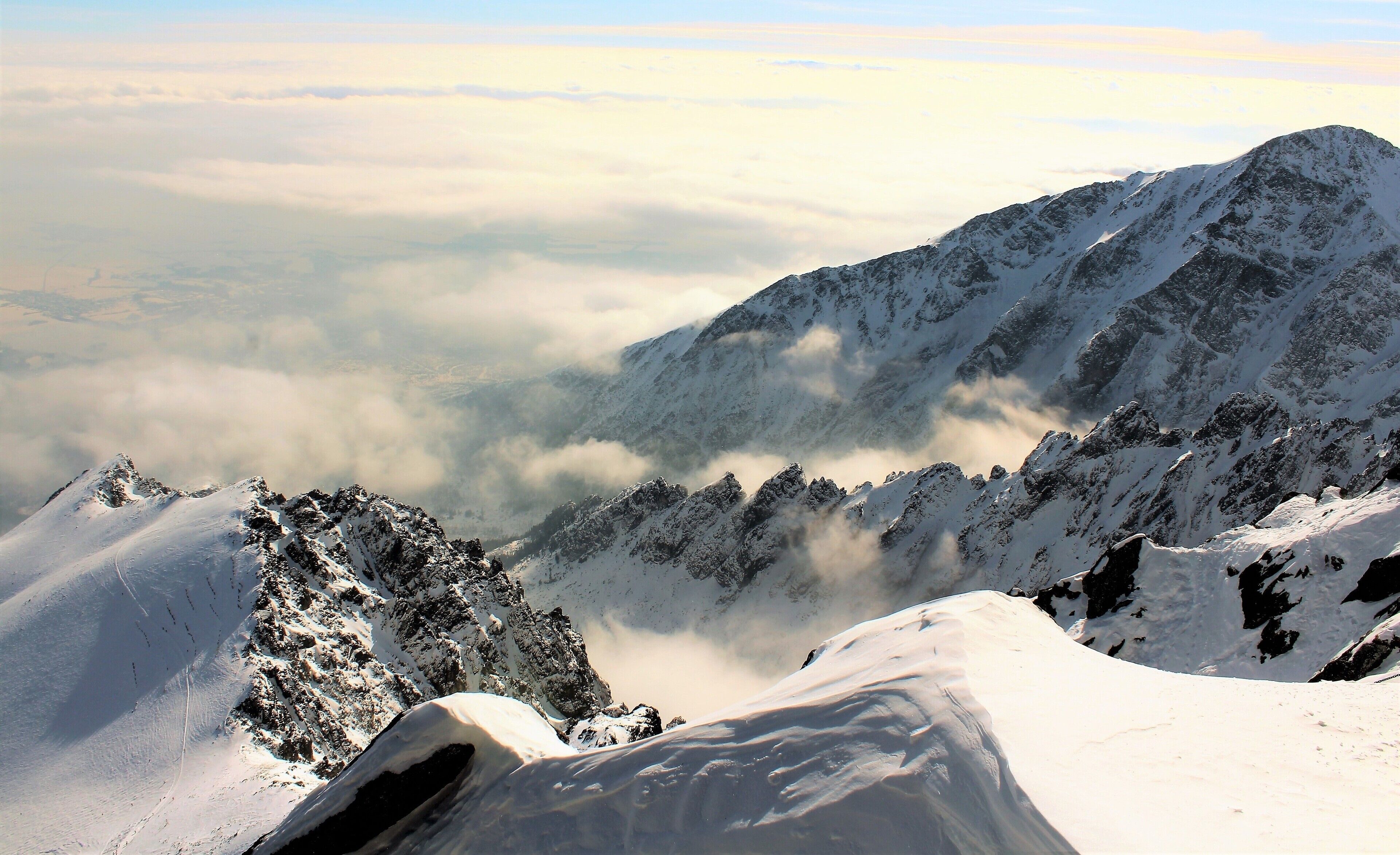 In the High Tatras, at Lomnický Peak. I was 2634 m/8641 ft above sea level. The mountains were breathtaking to see! But the wind was so strong I couldn't walk wherever I'd like! In fact I even lost my cap to the wind ;). It was incredible experience being up there. Exhilarating to say the least! I took the cable car up to Lomnický Peak (Slovak: Lomnický štít). And the views from there were also amazing. Lomnický štít is the 2nd highest peak in the High Tatras Mountains and one of the most visited in Slovakia. For very good reason! I took a lot of photos there even though I was holding my camera very, very tight!