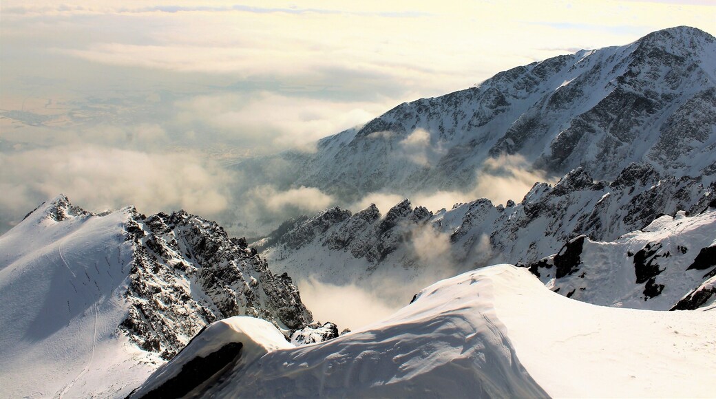 In the High Tatras, at Lomnický Peak. I was 2634 m/8641 ft above sea level. The mountains were breathtaking to see! But the wind was so strong I couldn't walk wherever I'd like! In fact I even lost my cap to the wind ;). It was incredible experience being up there. Exhilarating to say the least! I took the cable car up to Lomnický Peak (Slovak: Lomnický štít). And the views from there were also amazing. Lomnický štít is the 2nd highest peak in the High Tatras Mountains and one of the most visited in Slovakia. For very good reason! I took a lot of photos there even though I was holding my camera very, very tight!