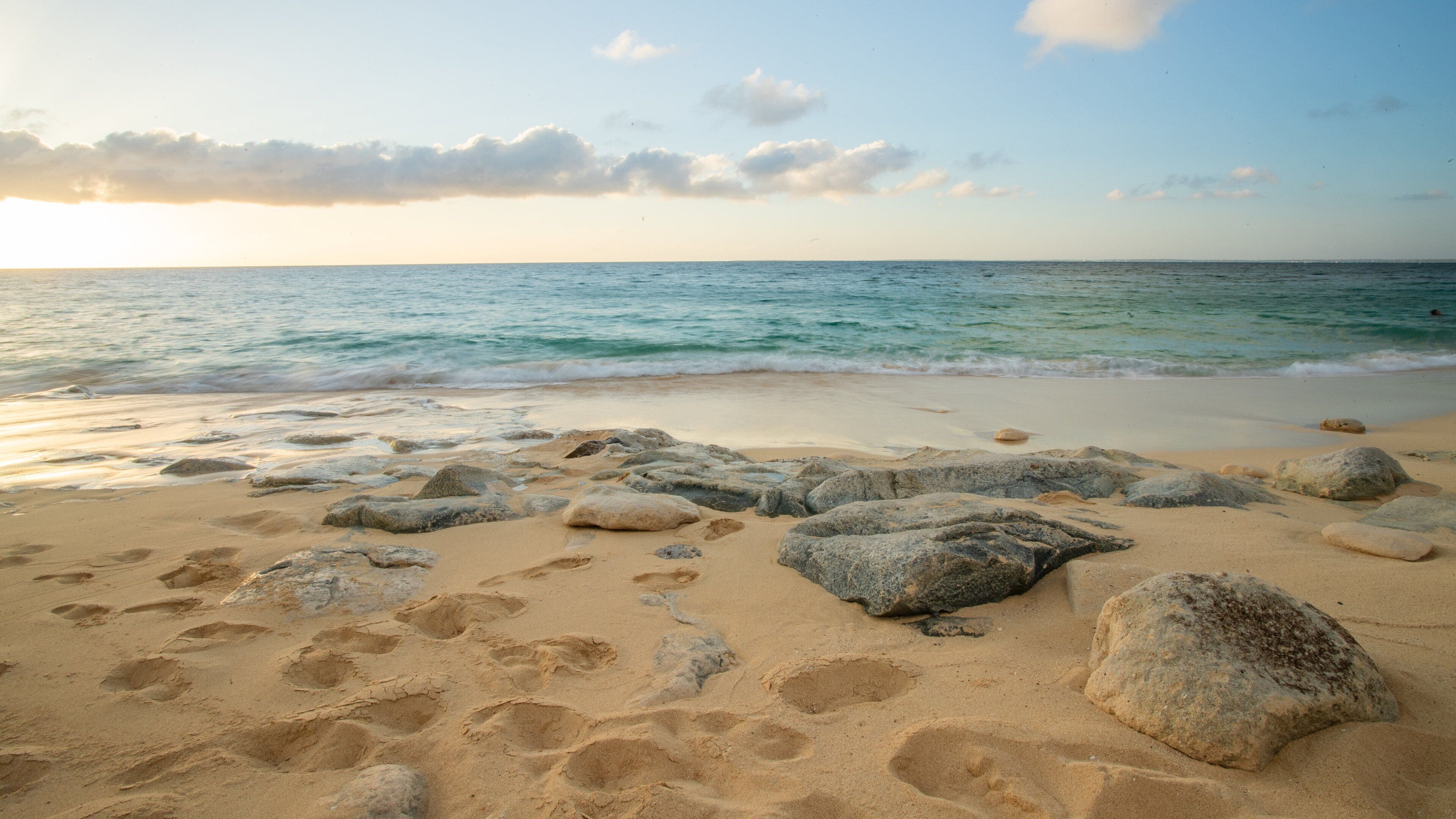 Saint Martin showing a beach, a sunset and general coastal views