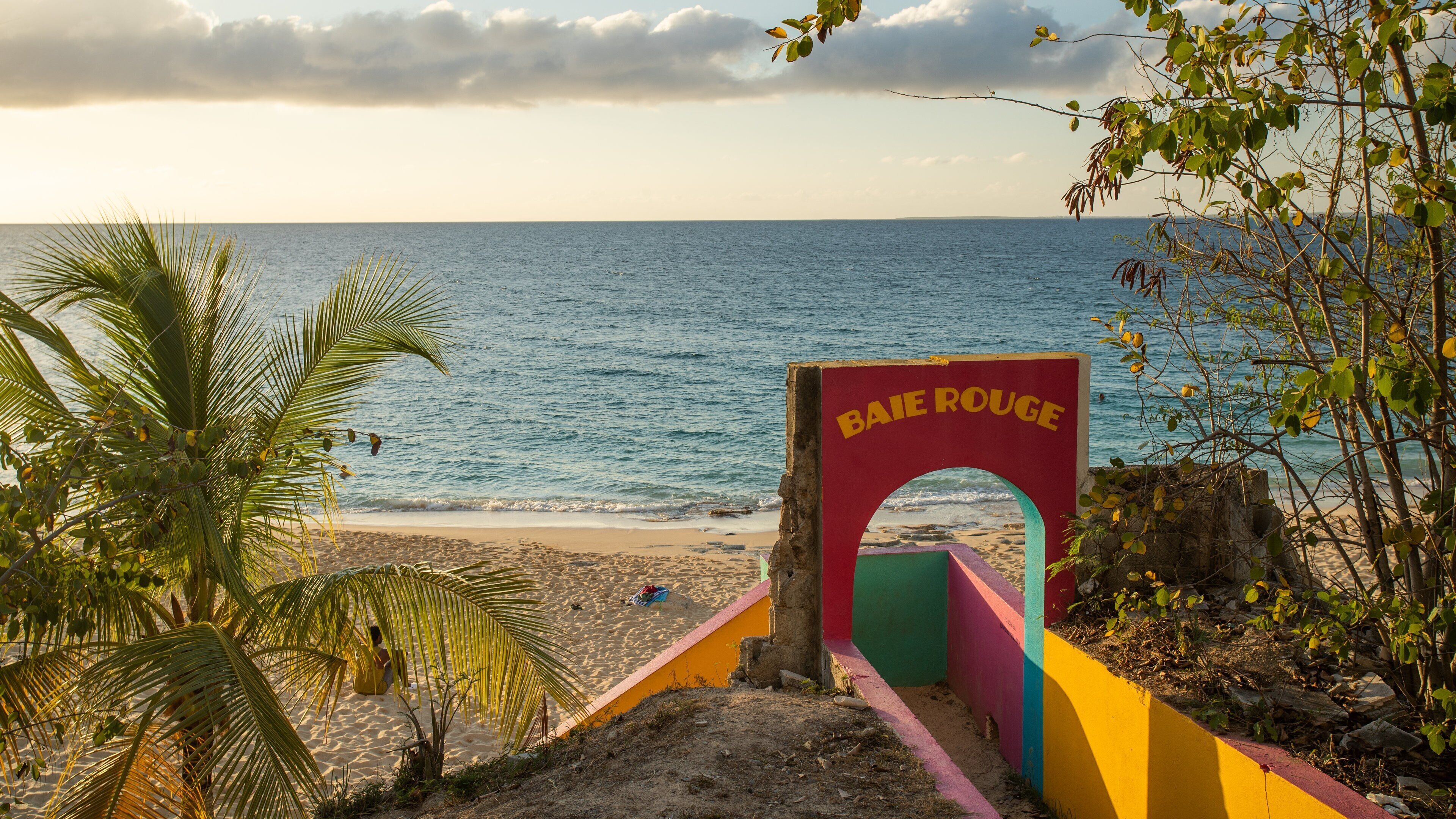 Saint Martin showing a sandy beach, a sunset and general coastal views