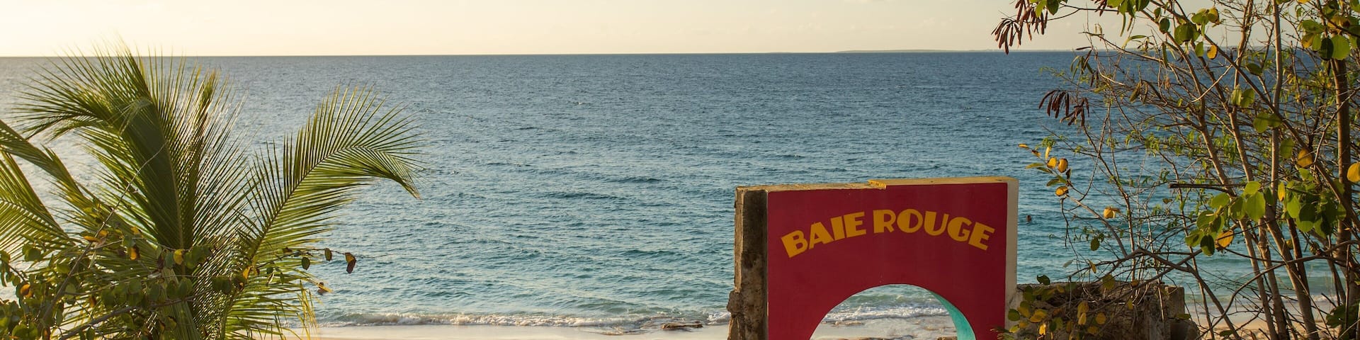 Saint Martin showing a sandy beach, a sunset and general coastal views