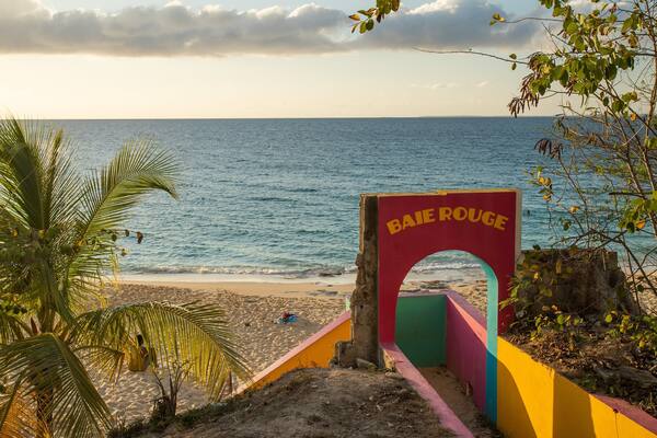 Saint Martin showing a sandy beach, a sunset and general coastal views