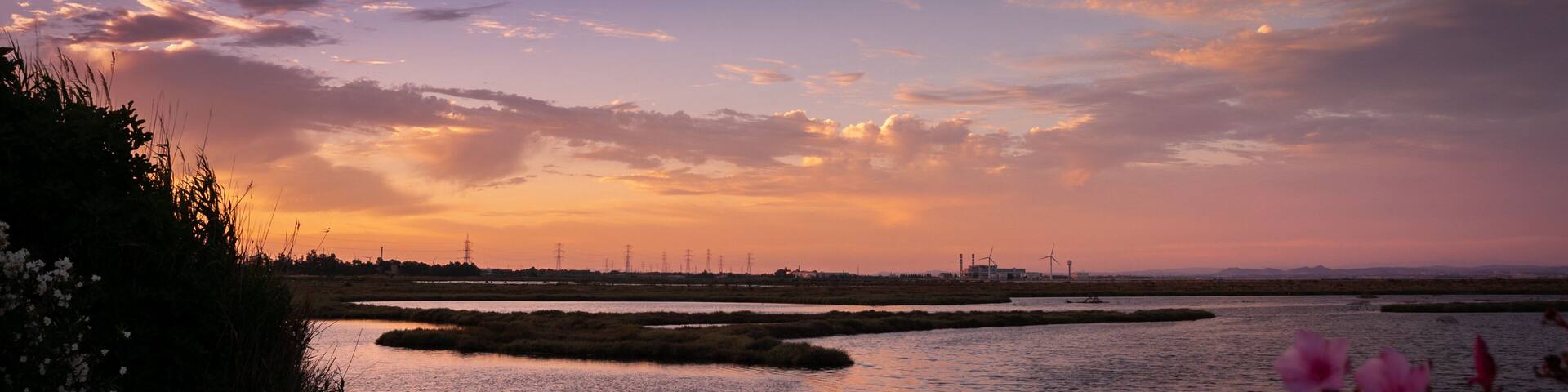 Capoterra, Cagliari, Sardinia. Sunset over the waters of the Santa Gilla lagoon. Pastel colored sky with clouds. The pond of Cagliari is one of the most important wetlands in Europe by extension and r