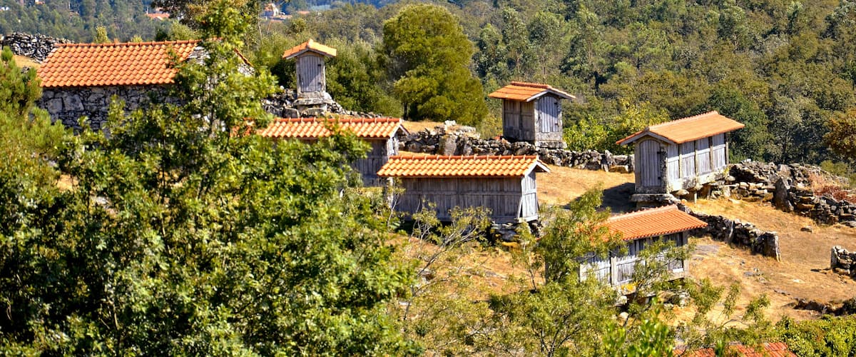 A rural village with stone houses and terraced fields.