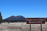 A sign indicating the Sunset Crater Volcano elevation at 8,039 ft.