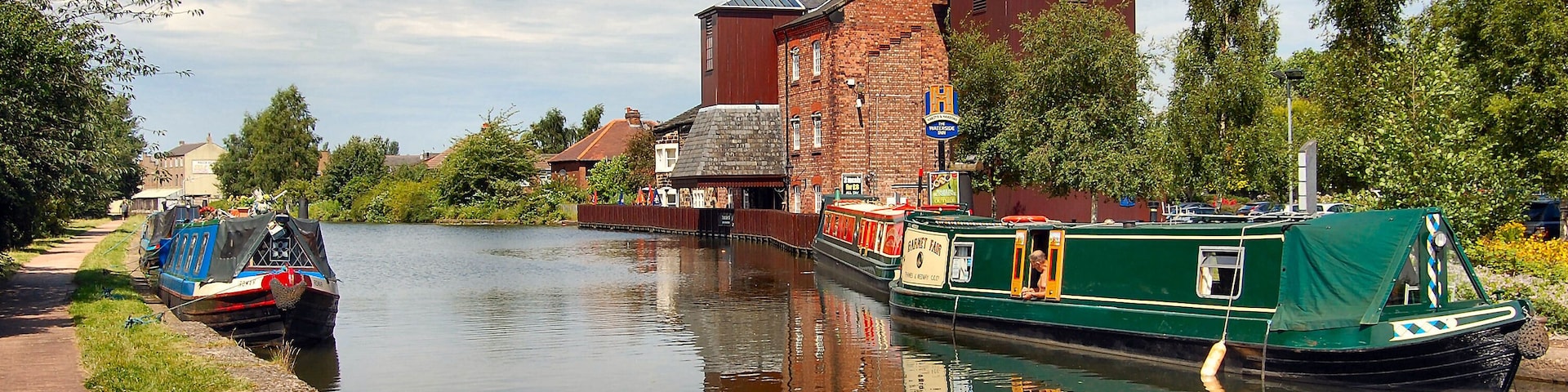 Taken in Leigh in Gtr Manchester. Near Warrington which is in Cheshire UK. The building on the right is a converted old mill which is now called The Waterside public house.Just perfect for mooring up and having a pint or two. Ron.