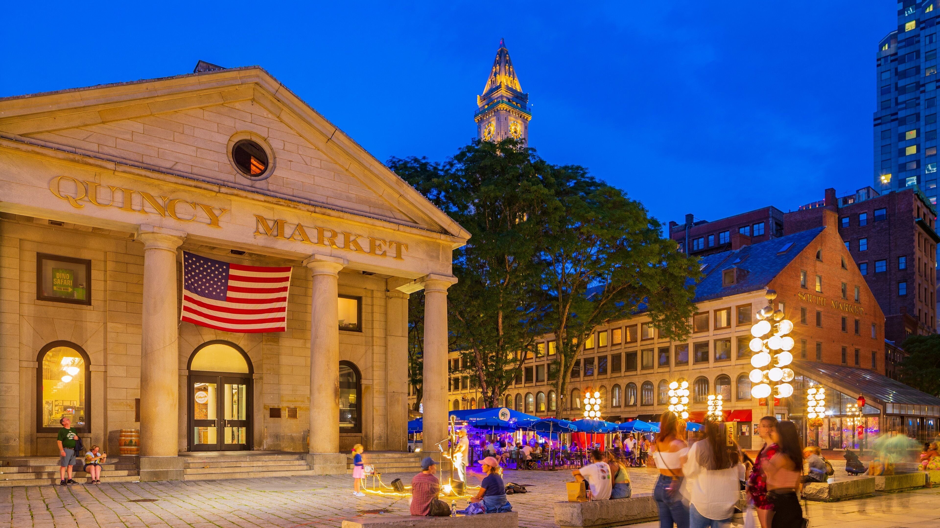 Faneuil Hall Marketplace which includes night scenes, heritage architecture and street scenes