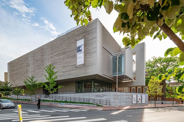 A modern building with a unique facade and a sign for Harvard Art Museums.