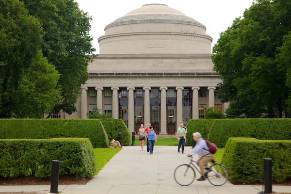 Massachusetts Institute of Technology featuring a garden as well as a small group of people