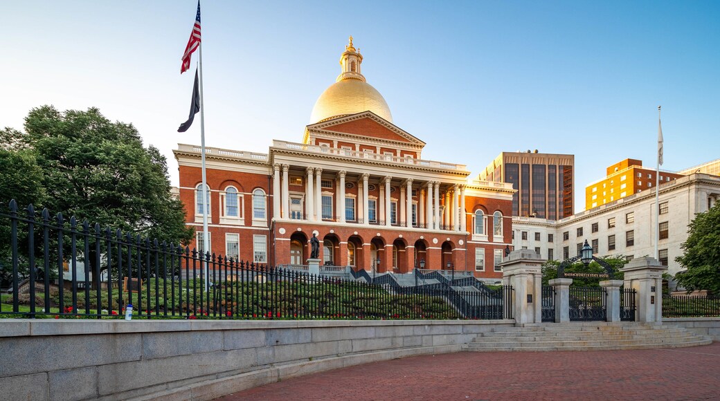 Massachusetts State House featuring heritage architecture and a sunset