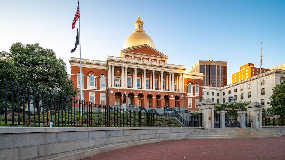 Massachusetts State House featuring heritage architecture and a sunset