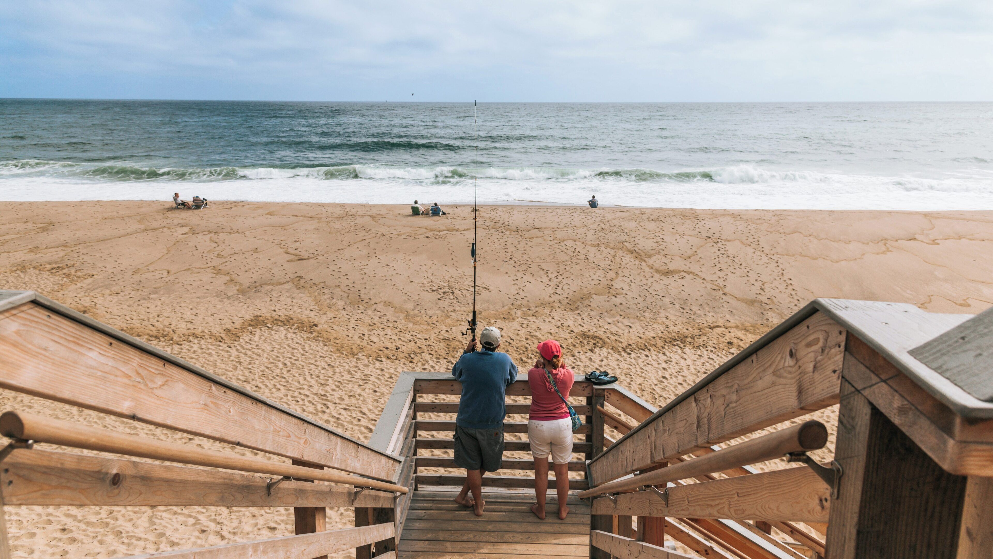 Fishing at Nauset Light Beach in Chatham, Massachusetts with scenic ocean views and sandy shores on a tranquil day