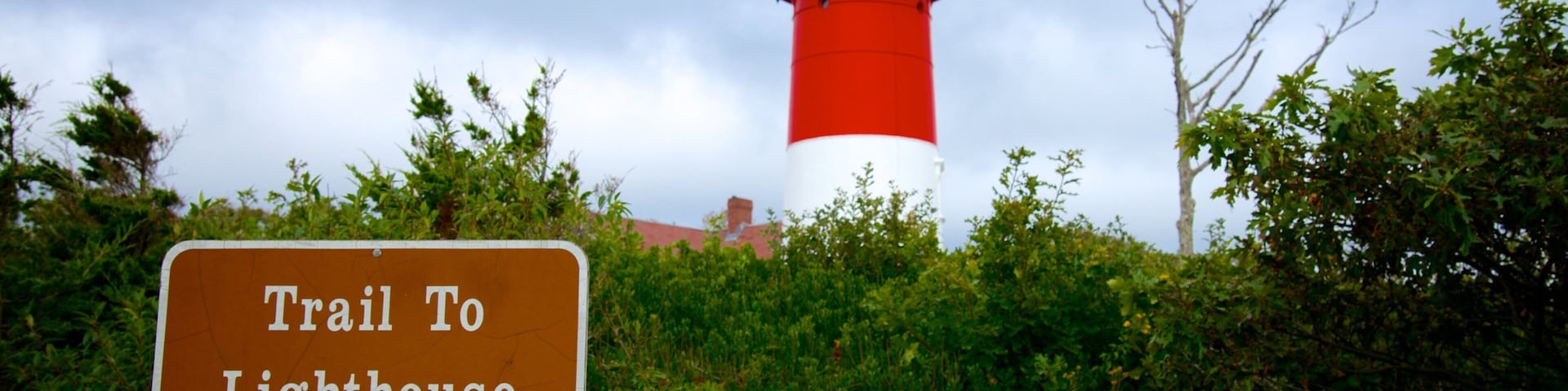 Nauset Light Beach featuring a lighthouse and signage