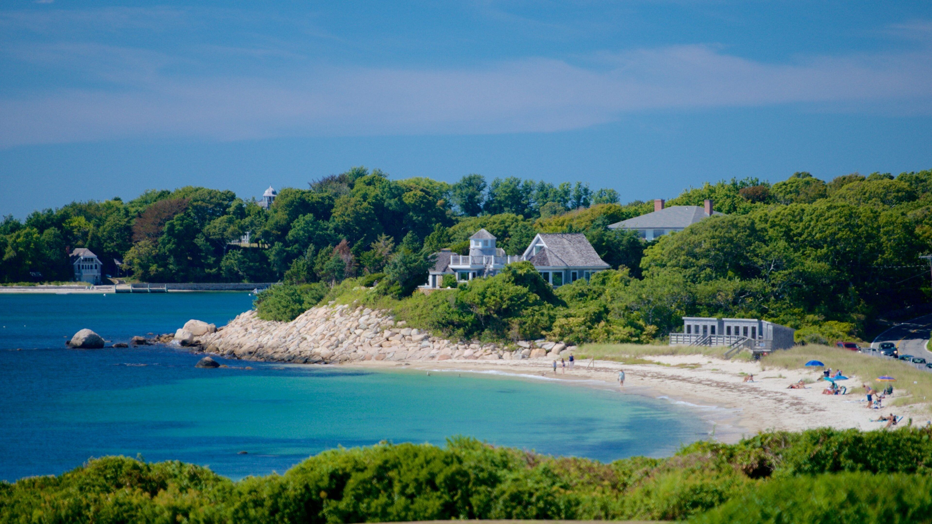 Nobska Lighthouse which includes a house, rocky coastline and a beach