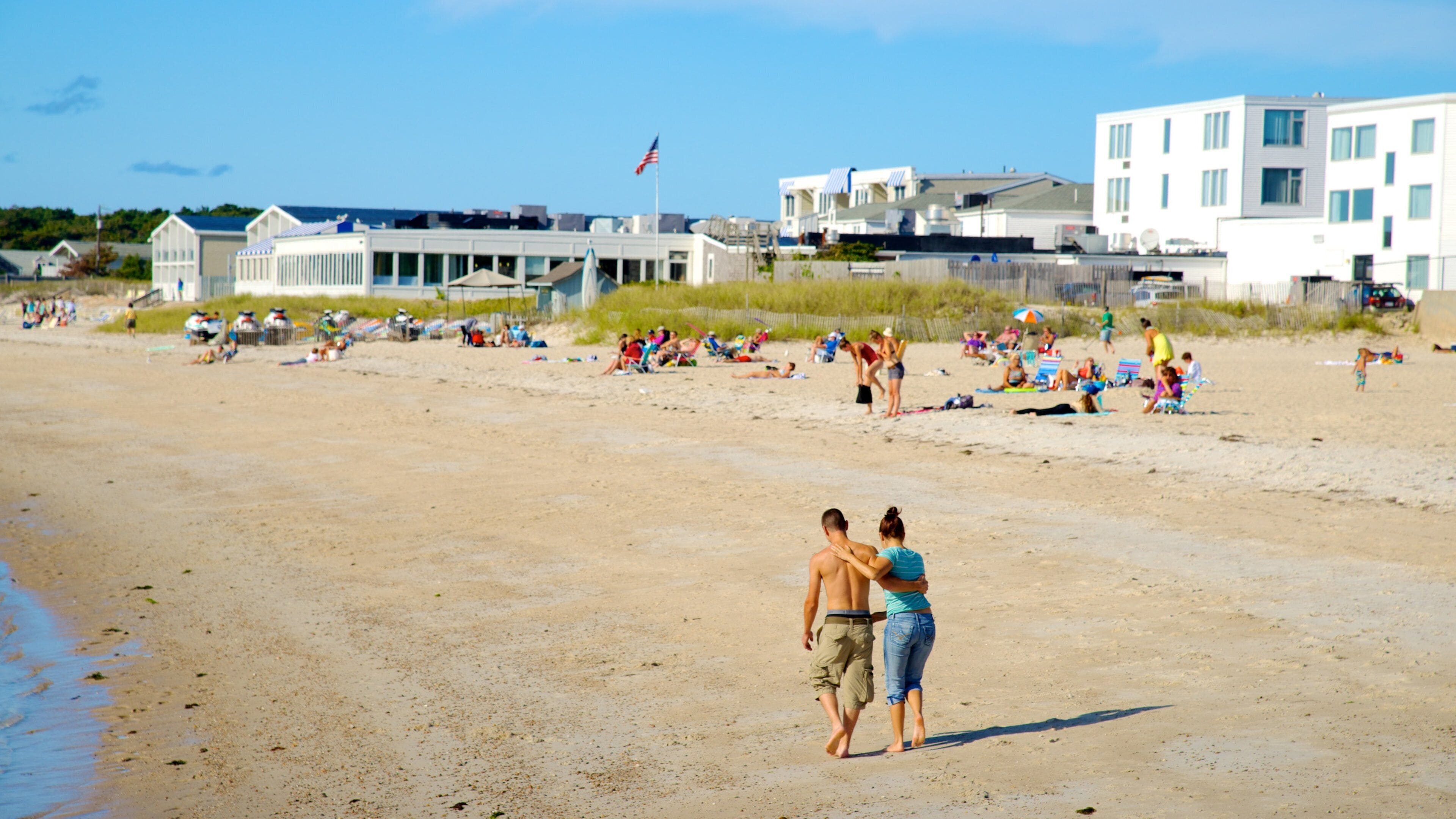 Old Silver Beach featuring a sandy beach as well as a small group of people