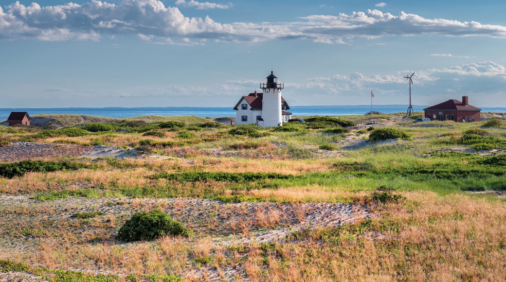 Sand dunes on the beach and Race Point Light Lighthouse in Cape Cod, New England, Massachusetts, USA.