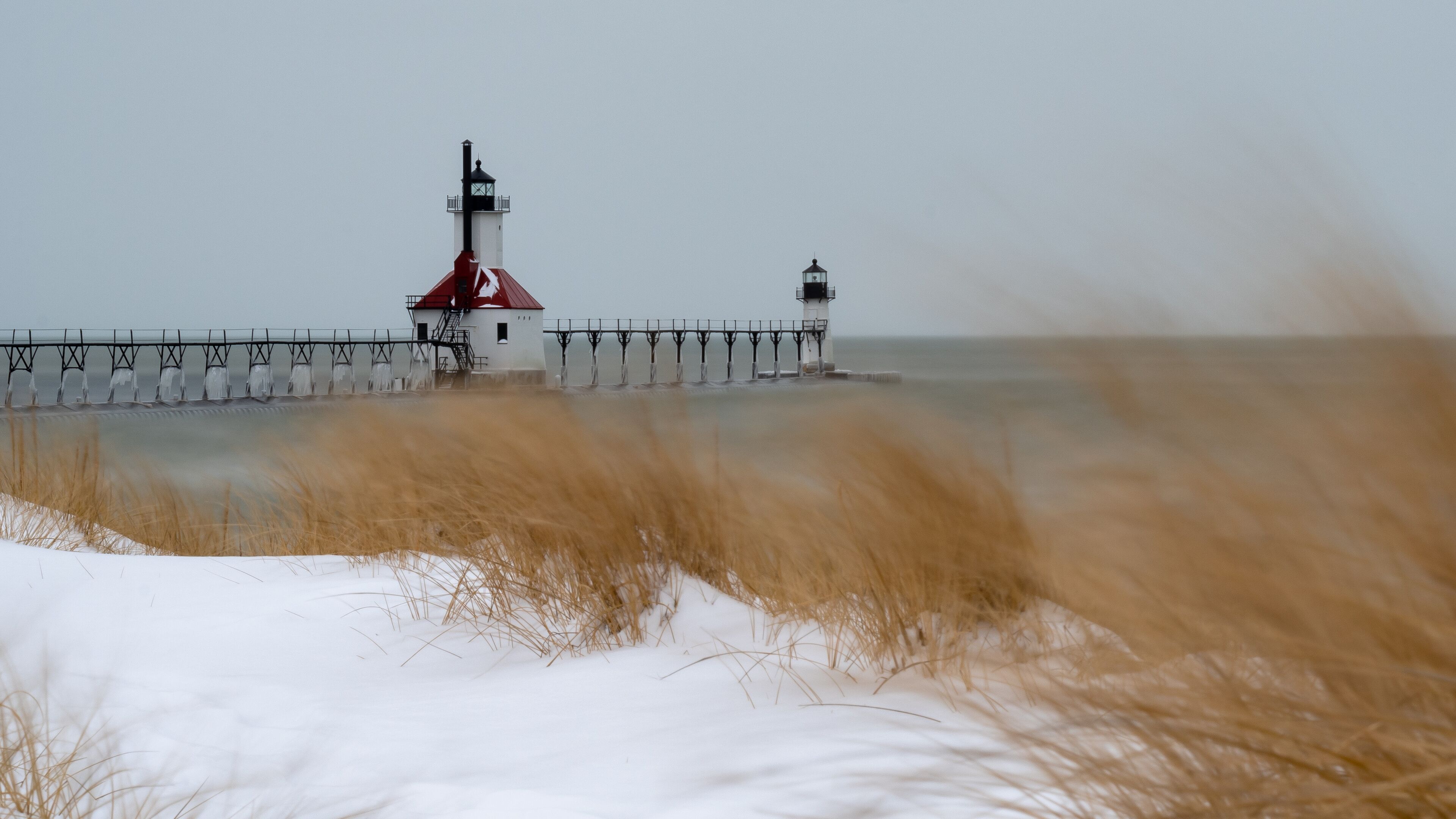 St. Joseph Michigan North Pier Lighthouse setting at the mouth of the St. Joseph river as it empties into mighty Lake Michigan protecting boats from the shallow waters and providing a light beacon