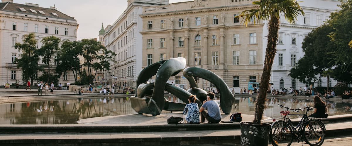 Karlsplatz showing a fountain and a sunset as well as a couple