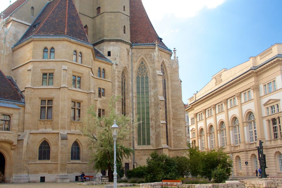 A historic building with a tall tower and arched windows.