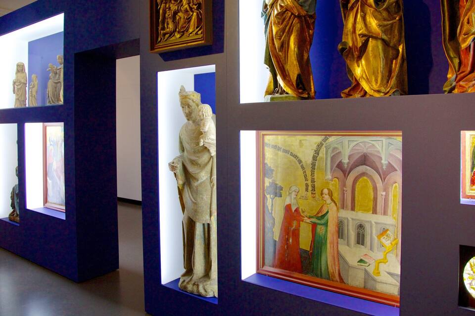 A museum exhibit with various sculptures and paintings.