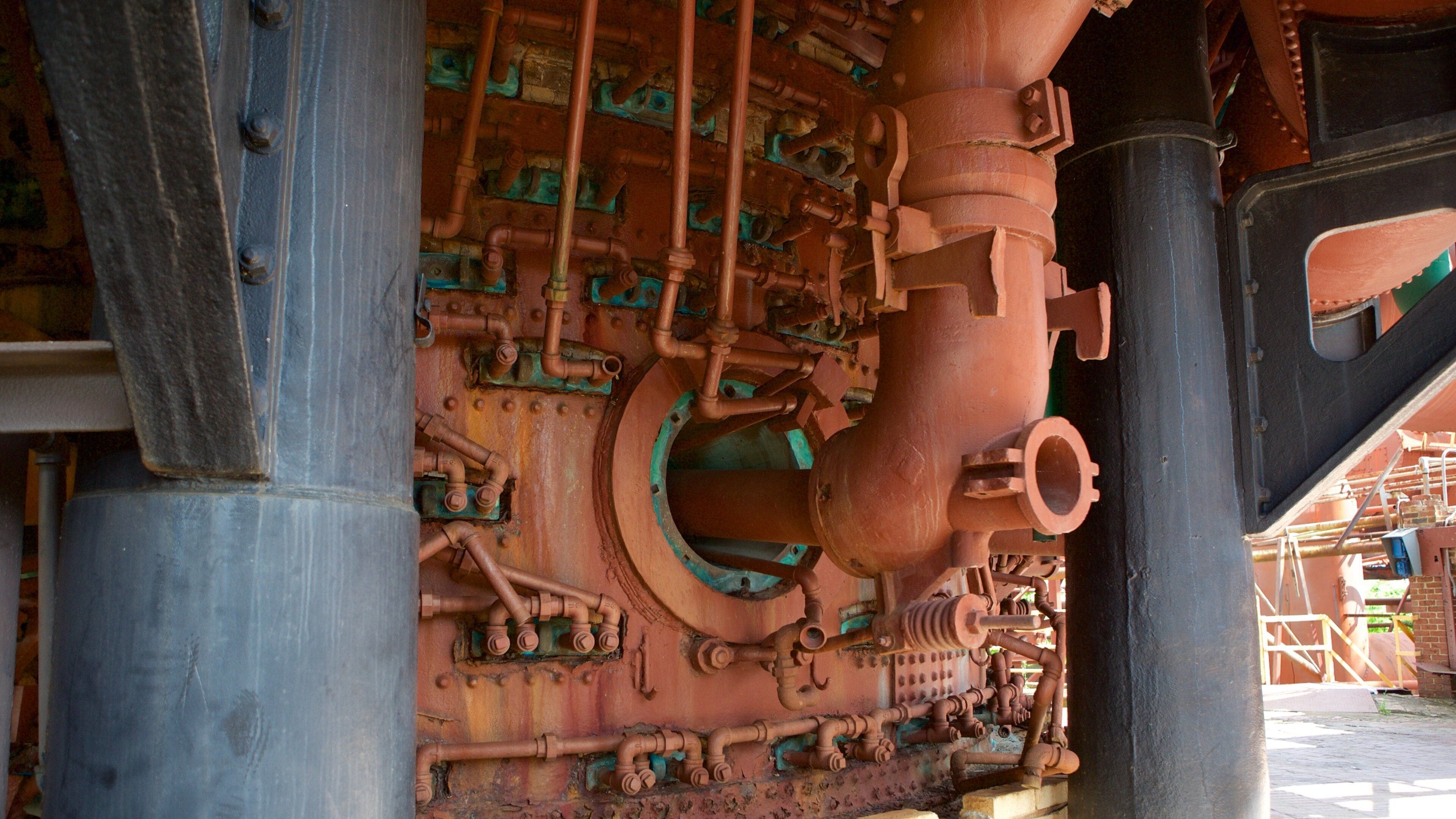 A large industrial structure with complex piping and mechanical components.