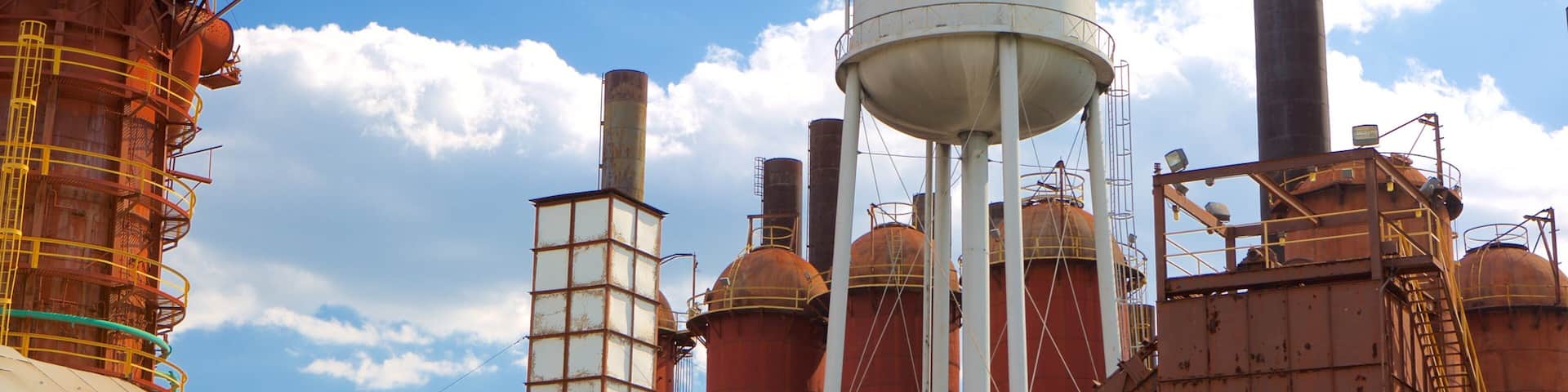 A large industrial complex with multiple silos and a water tower labeled 'SLOSS'.
