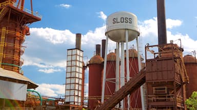 A large industrial complex with multiple silos and a water tower labeled 'SLOSS'.