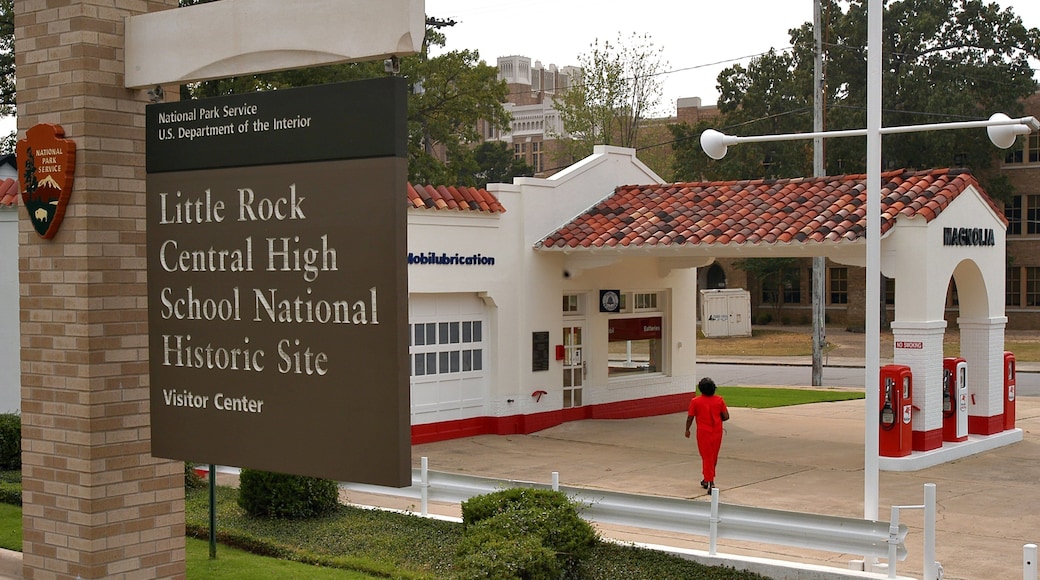 Little Rock Central High School which includes signage as well as an individual femail