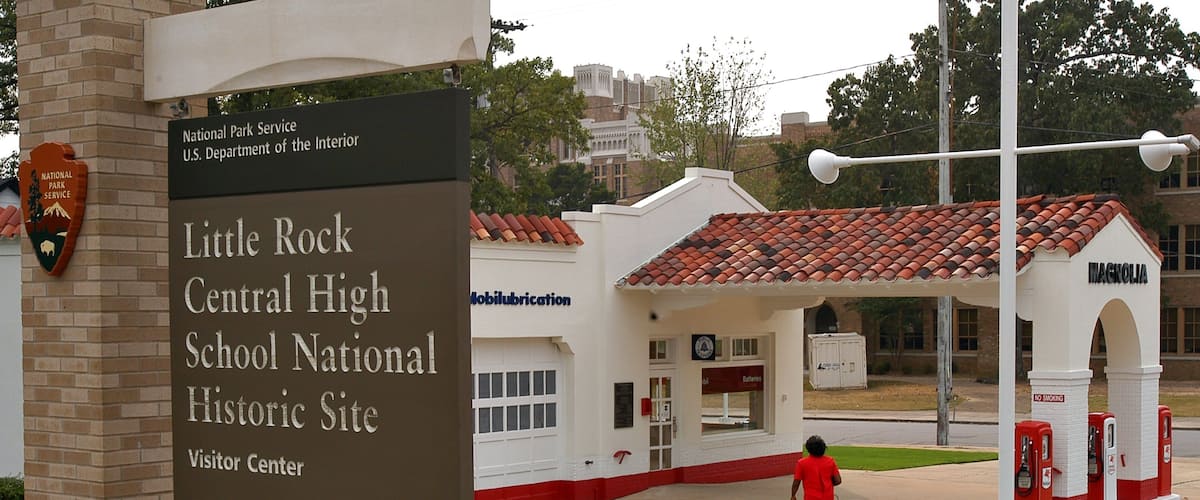 Little Rock Central High School which includes signage as well as an individual femail