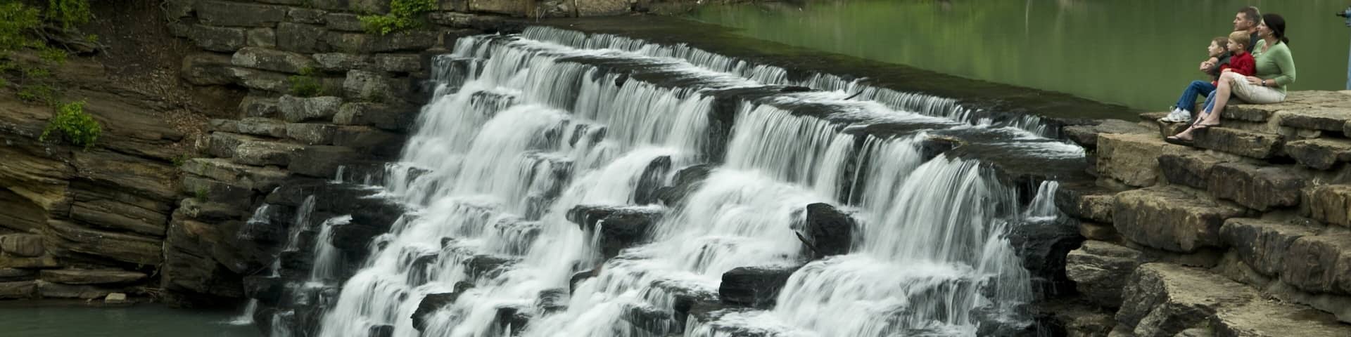 Devil\'s Den State Park which includes a waterfall and a lake or waterhole as well as a couple