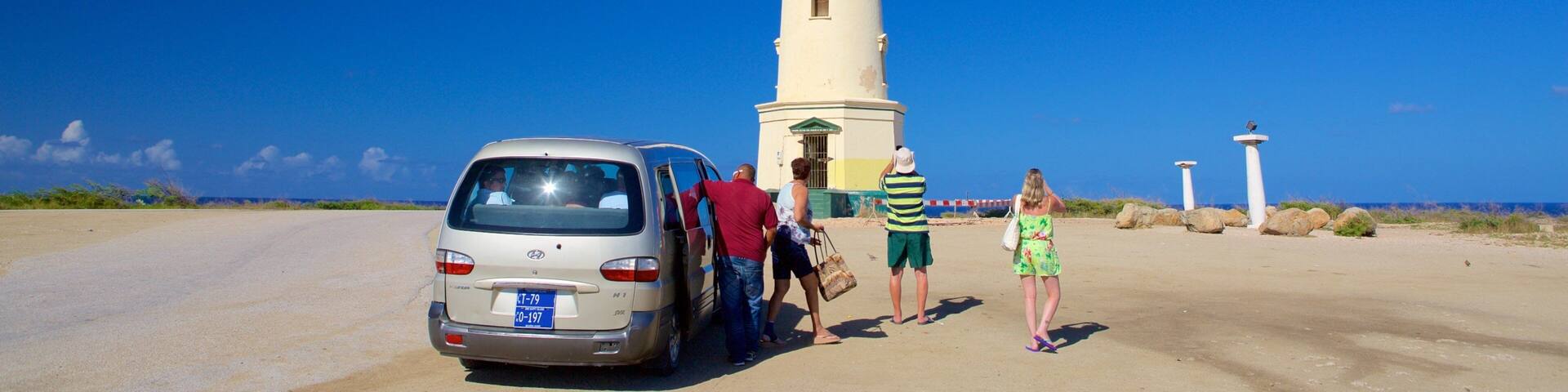 A tall white lighthouse with a clear blue sky in the background.