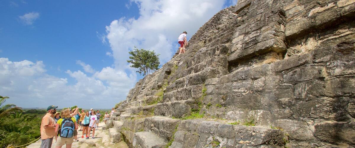 A group of hikers on a rocky trail with a clear sky.