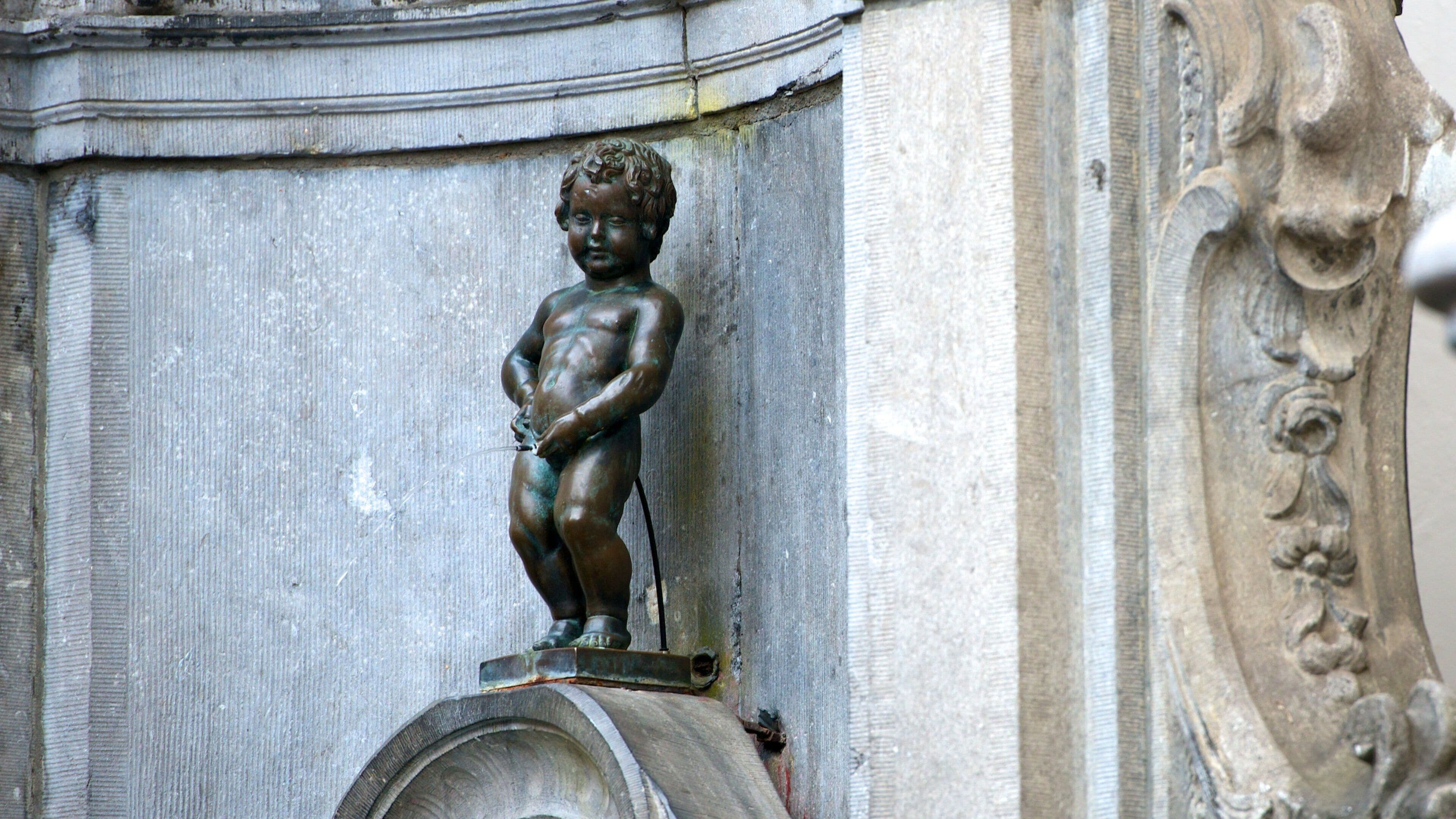 Manneken Pis Statue featuring a statue or sculpture and art